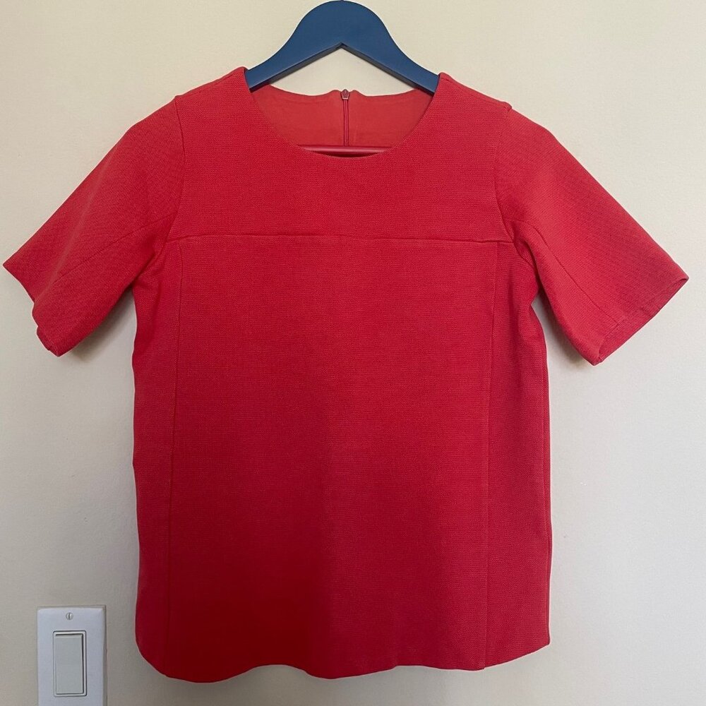 Coral-red women's top in size S, featuring half sleeves, and round neckline.